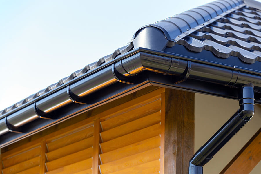 tile metal roof with steel gutter and downspout