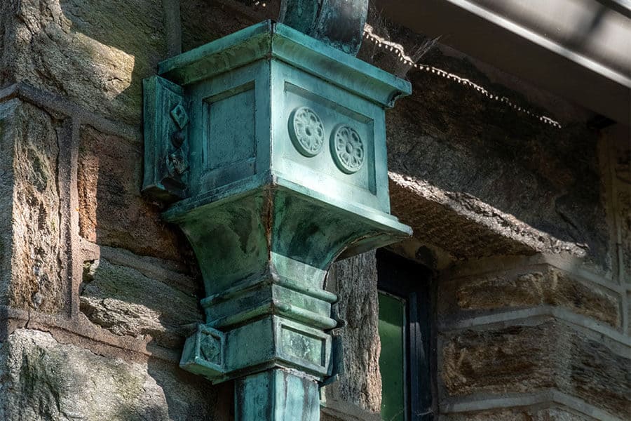 beautiful aged ornate copper leaderhead covered with natural patina